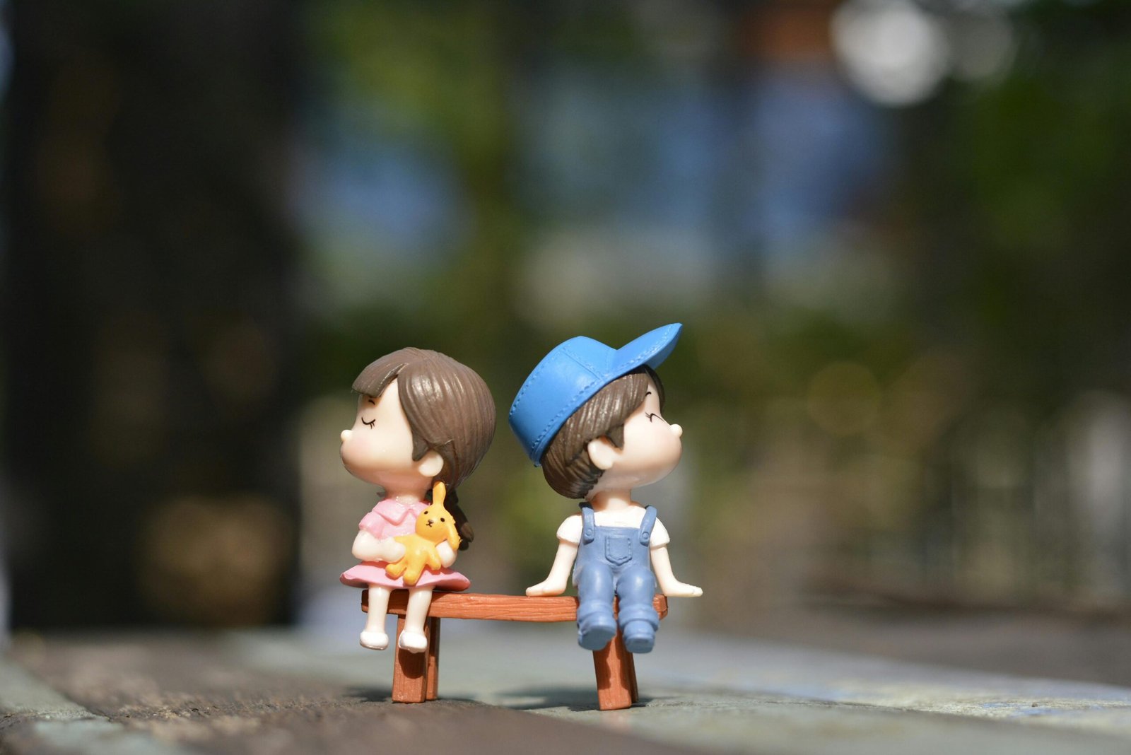 Boy and Girl Sitting on Bench Toy